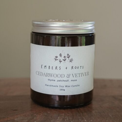 Cedarwood & Vetiver soy candle in an amber jar with a silver lid